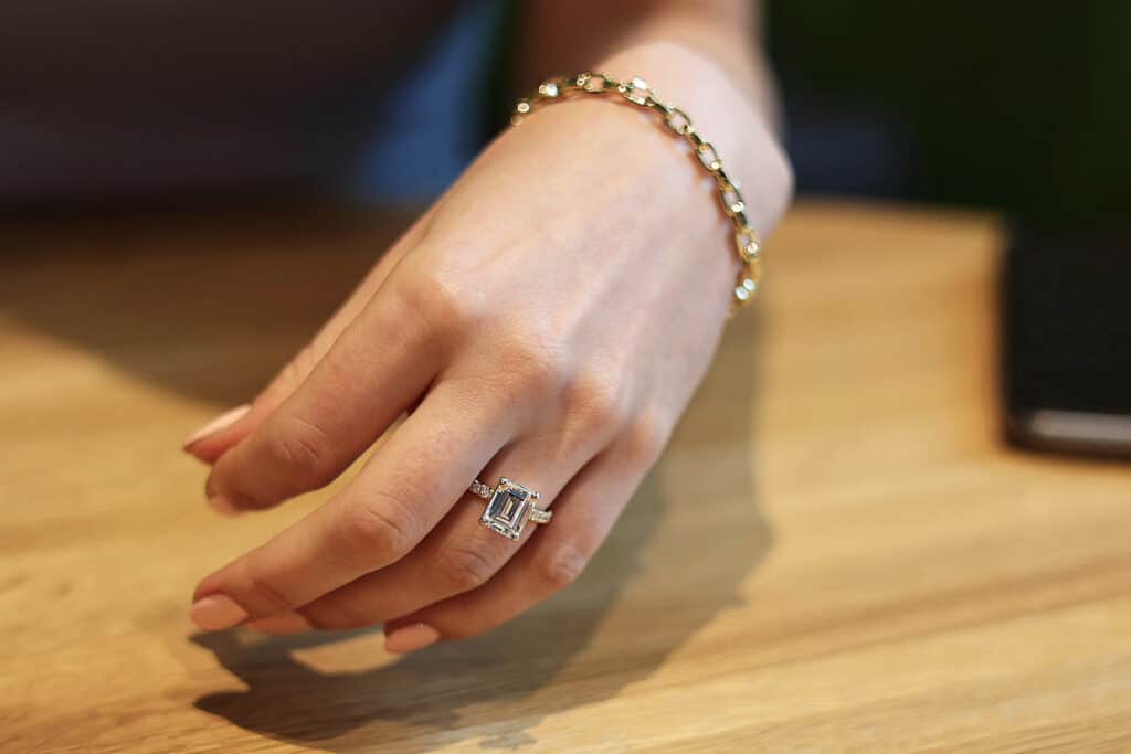 Emerald Cut Diamond in a Scalloped engagement ring setting
