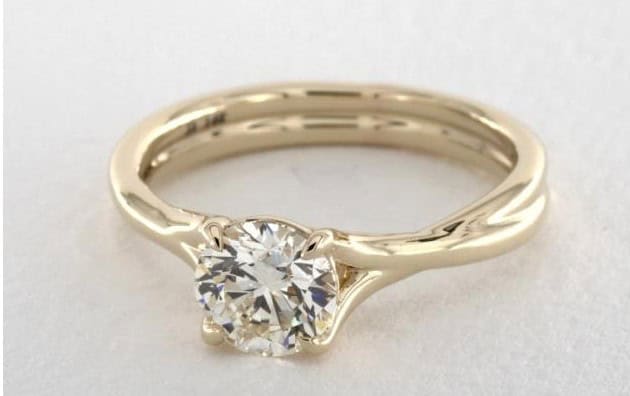 K color diamodn in a yellow gold setting