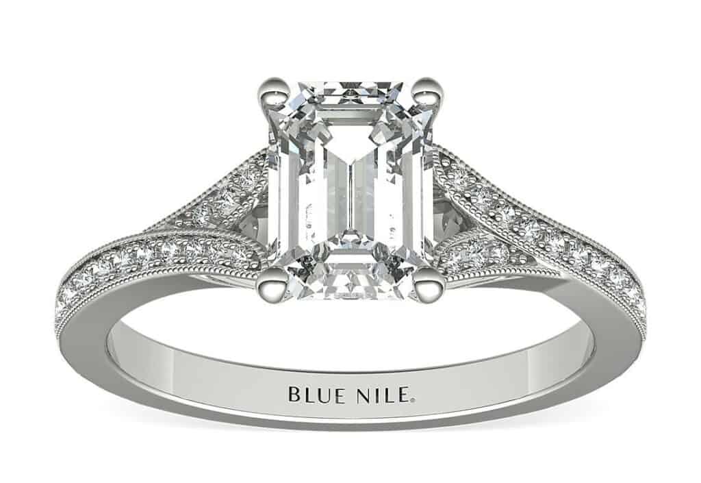 A Milgrain vintage setting in White Gold with an emerald cut diamond in the center