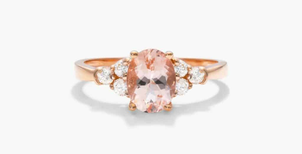 Oval morganite ring with three diamonds on each side