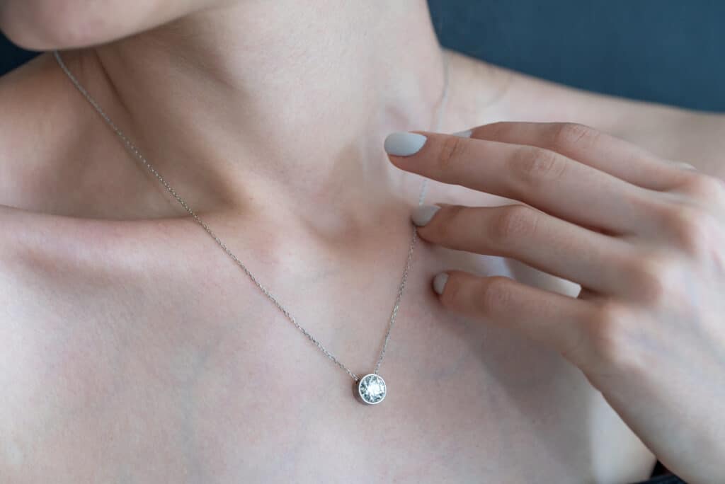 An example of a diamond pendant on woman's neck